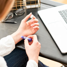 Load image into Gallery viewer, Puressentiel Rest & Relax Stress Roll-on in use